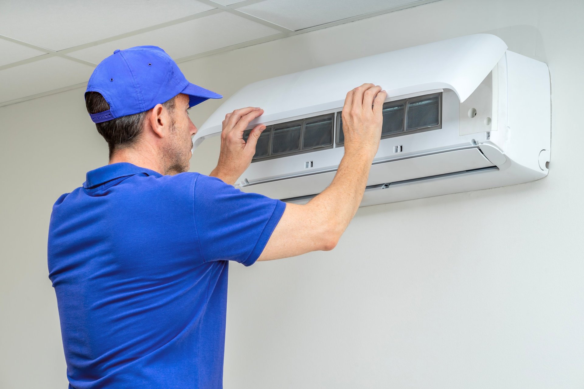 Professional HVAC technician performing maintenance